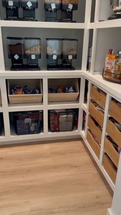 an organized pantry with bins and baskets