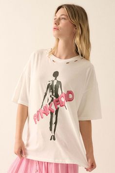 Distressed, garment washed graphic t-shirt. Torn and distressed detailing at neckline, cuffs, and hem. Vintage-style Pink Floyd graphic print with silhouette art inspired by the Shine On box set. Round neckline. Short sleeves. Drop shoulder. Oversized fit. 100% Cotton. Imported top designed and printed in LA. Officially licensed Pink Floyd merchandise. Model wears size S. Edgy White T-shirt For Spring, Oversized T-shirt With Frayed Hem For Spring, Spring Distressed Graphic Tee T-shirt, Trendy Oversized Ripped Tops, White Ripped Tops For Spring, Spring Acid Wash T-shirt With Frayed Hem, Trendy Oversized Distressed T-shirt, Trendy Ripped T-shirt For Summer, Spring Distressed Grunge T-shirt