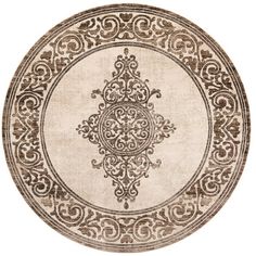 a round rug with an ornate design on the center and sides, in beige tones