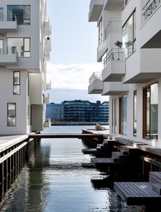 an empty waterway between two buildings with balconies