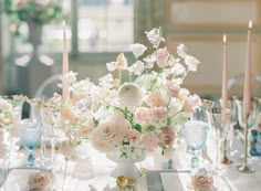 a table topped with lots of white and pink flowers