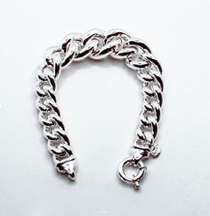 Brand: Argentidea Jewelry Instagram: https://www.instagram.com/gioielli_argentidea/ Measurement: 20.5 cm Weight: 47g. Silver colour Eye-catching women's bracelet, in 925 silver, grumetta chain with graduated links. The bracelet is a gradual lump link chain, the central measurement has a width of 20 mm up to the final links which have a width of 12 mm. The bracelet features a spring ring clasp with two micro-cast ends for a better finish. The bracelet is the natural color of silver, manually poli Modern Chunky Bracelets As Gift, Modern Chunky Bracelet For Gift, Chunky Silver Bracelet Jewelry, Chunky Sterling Silver Bracelet As Gift, Chunky Sterling Silver Bracelets As Gift, Modern Chunky Silver Jewelry, Elegant Chunky Silver Chain Bracelet, Modern Chunky Silver Bracelet, Elegant Sterling Silver Chunky Chain Bracelet