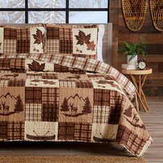 a brown and white quilted comforter set on a bed