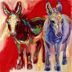 two colorfully painted donkeys standing next to each other on a red and yellow background