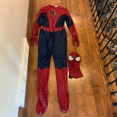 a spider man costume laying on top of a wooden floor