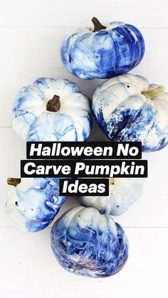 blue and white painted pumpkins sitting on top of each other