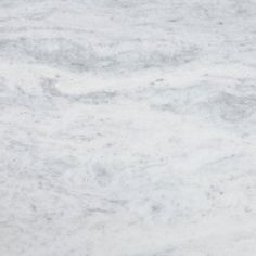 a white marble counter top textured with grey and white paint