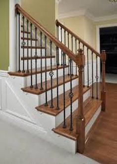 the stairs in this house are made of wood and wrought iron, with handrails