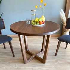 The Muse mid-century round dining table, showcasing its elegant wood finish and modern design. Wood Round Dining Table, Round Dining Table Set, Dining Room Shelves, Dining Table Brown, Round Dining Table Sets, Round Wood Dining Table, Live Edge Coffee Table, Live Edge Dining Table, Large Dining Room