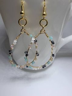 These delicate beaded wire hoops are attached to 18k gold plated brass ear wires that are nickel free. The tiny faceted glass beads are black, champagne, white, and minty green. This color combo lends itself to multiple oufit pairings making this a versatile accessory. Earrings Making, Minty Green, Beaded Jewellery, Beads Earrings, Wire Work Jewelry, Earrings Inspiration, Work Jewelry, Handmade Wire Jewelry, Ear Rings