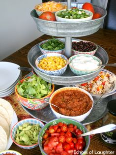 a table topped with bowls filled with different types of food and salads on top of it