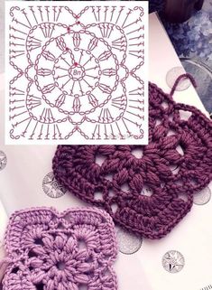 two crocheted purses sitting next to each other on top of a table