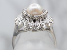 Formal Diamond White Pearl Ring With Center Stone, Formal Pearl Ring With Diamond Halo Design, Formal Diamond Pearl Ring With Halo Design, Vintage Formal Halo Ring, Vintage White Diamond Ring With Halo Setting, Classic White Gold Pearl Ring With Halo Design, Formal Diamond Pearl Ring With Halo, Formal Diamond Halo Pearl Ring, Vintage White Pearl Ring With Brilliant Cut