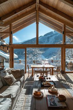 a living room filled with furniture next to a large window covered in frosted snow