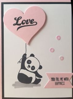 a card with a panda holding a heart shaped balloon