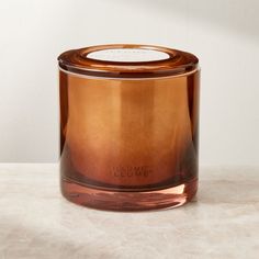 Designed as a centerpiece item, triple-wick candle by Illume builds upon a base of warm cashmere musk with notes of tobacco leaf and sweet orange. The soy wax blend is hand-poured into a dark amber glass vessel with an ombre effect that's nothing short of mesmerizing when flames flicker within.  -Handmade -Soy and paraffin wax blend -Three lead-free wicks -Vegan and cruelty-free -Green glass vessel with matte brass lid -20.8 ounces -Burn time of up to 60 hours -Trim wick to 1/4andamp;quot; befor White Pillar Candles, Unique Candle Holders, Led Pillar Candle, Candles For Sale, Tea Tree Essential Oil, Bowl Candle, Brass Candle, Black Candles, Unique Candles