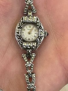 "Here is a beautiful Rotary vintage Ladies Marcasite Art Deco style 17' Jewels Mechanical dress WatchSwiss Made. I think the metal is rhodium plated. The watch itself is very Art Deco in style but was probably made in the 1950-60s. It is in great vintage condition and is complete with a safety chain. It measures an approximate length of just under 7\"." Luxury Antique Watch Accessories For Formal Occasion, Silver Art Deco Watches For Weddings, Art Deco Silver Wedding Watches, Vintage Silver Metal Jewelry And Watches, Antique Silver Diamond Watch, Art Deco Silver Diamond Watch For Weddings, Formal Art Deco Silver Diamond Watch, Silver Art Deco Diamond Watch For Wedding, Silver Art Deco Diamond Watch For Anniversary