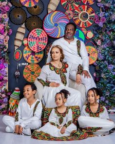 the family is posing for a photo in front of colorful decorations