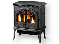 a black stove sitting on top of a wooden floor