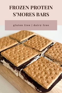 a wooden cutting board topped with chocolate covered grahams and s'mores bars