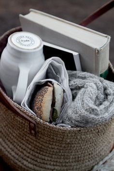 a basket filled with food sitting on top of a table next to an open book