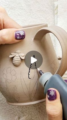 someone is painting a vase with flowers and bees on it