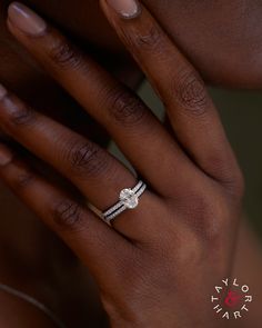 a woman's hand with a diamond ring on it