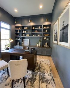 a home office with built - in shelving and desk