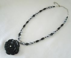 "Black Rose Necklace This beautiful necklace has black pearl beads, silver pearl beads, pewter silver accent beads, sterling silver plated filigree beads, sterling silver plated bead caps, seed beads, sterling silver plated chain and a pewter silver pendant with resin rose. 16\" long can be adjusted to 20\" long. Sterling silver plated lobster clasp." Elegant Metal Necklace With Black Beads, Elegant Silver Pearl Necklace With Black Beads, Elegant Silver Necklace With Black Beads, Elegant Silver Beaded Necklaces With Black Beads, Elegant Silver Beaded Necklace With Black Beads, Resin Rose, Jewelry Victorian, Victorian Necklace, Necklace Gothic