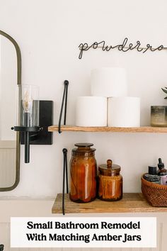 small bathroom remodel with matching amber jars and candle holders on the shelf above