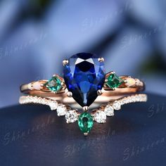 an engagement ring with a blue and green gems