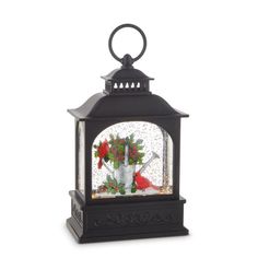 a black lantern with flowers and birds in it