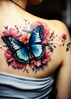 a woman's shoulder with a butterfly and flowers on it