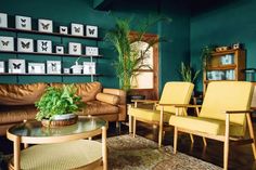 a living room filled with furniture and green walls