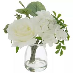 white flowers are in a clear glass vase