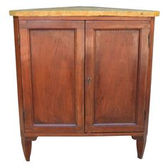 an old wooden cabinet with marble top