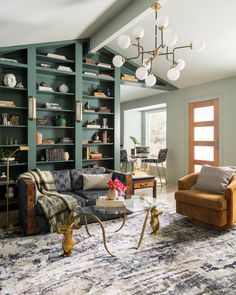 a living room filled with furniture and bookshelves