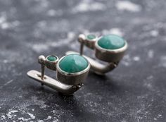 Emerald Earrings set with Natural Emerald stone, great natural color (untreated & undyed = rare) with small Emerald on top, sourced from Colombia, measuring 10x8 mm each stone, 6 Carats for a pair. Unique Earrings Design made of Solid 925 Sterling Silver (no “coating" ☞ only Solid Pure Silver - made to last) Matching Rings ☞ please ask meMatching Pendant ☞ please ask me Details:♥ Natural Emeralds sourced from Colombia♥ Emeralds: 10x8mm each, 6 Ct a pair, cabochon cut♥ Small Emeralds: 3mm each, 0 Oval Earrings, Oval Earring, Emerald Earrings, Matching Rings, Emerald Stone, Green Earrings, Natural Emerald, Unique Earrings, Pure Silver