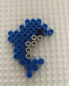 several blue and white balls are arranged in the shape of a star on a white surface