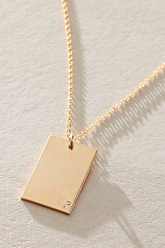 So unique in an understated design, this stunning necklace features a personalized rectangle pendant with initial engraved at corner for a super fun finishing touch. * 14k Gold Filled * 0.5x0.75" rectangle bar necklace with hand-stamped personalization * Length: 20" * 5 days of production | Set & Stones Personalized ie Necklace at Free People in Gold Luxury Engraved Necklace With Rectangular Pendant, Engraved Rectangular Pendant Initial Necklace As Gift, Minimalist Engraved Initial Necklace With Rectangular Pendant, Gold Necklaces With Engraving Option, Rectangular Pendant, Personalized Initial Necklace With Rectangular Pendant, Stone Gold, Personalized Initials, Stunning Necklace, Bar Necklace