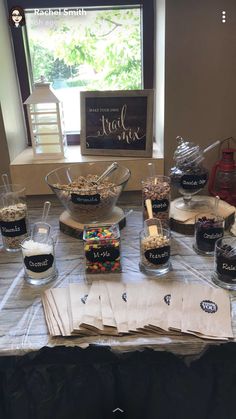 a table topped with lots of different types of desserts and candies on top of paper towels