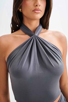 Effortless summer.The BRONWYN Slinky Halter Crop Top is a perfect blend of modern style and elegant design. This top features a halter neckline with a secure button closure at the back of the neck, ensuring a comfortable fit. The front ruching adds a chic detail, enhancing the overall look. The open back, accented by a tie back closure, creates a striking silhouette that's both bold and sophisticated. Pair it with the Bronwyn Slinky Ruched Maxi Skirt With Split for a cohesive and stunning ensemb Capsule Wardrobe Accessories, Skirt With Split, European Summer Outfits, Wardrobe Accessories, Capsule Outfits, Black Tie Wedding, Beige Dresses, Halter Crop Top, Crepe Dress