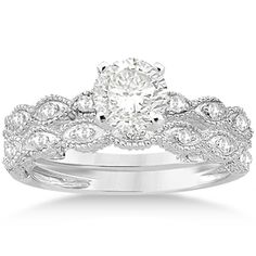 a wedding ring set with an oval diamond in the center