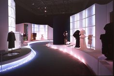 a room filled with lots of mannequins on display