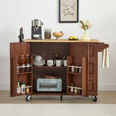 a kitchen cart with an open door and shelves on the side, holding various items