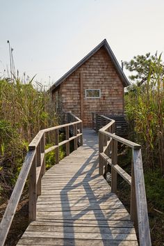 a wooden walkway leading to a small building