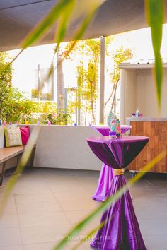 a table with purple cloth on it in the middle of a patio