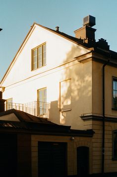 a large white house with a black roof