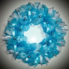 a blue wreath with silver pins and bows