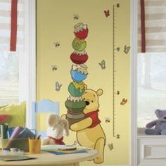 a winnie the pooh growth chart wall decal in a child's room